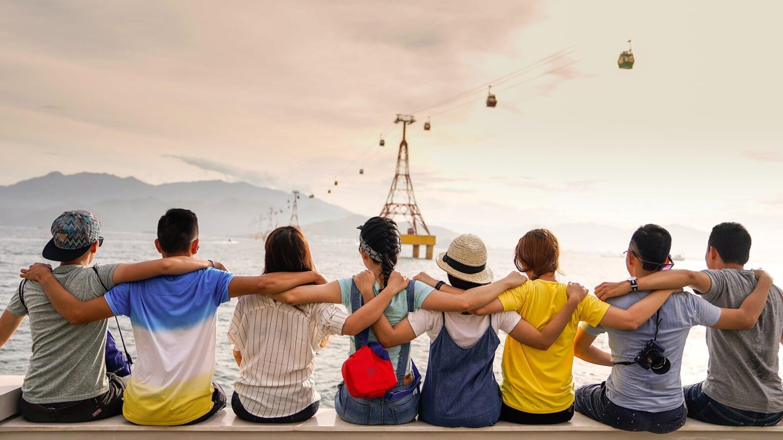 Group hugging while watching land in the distance