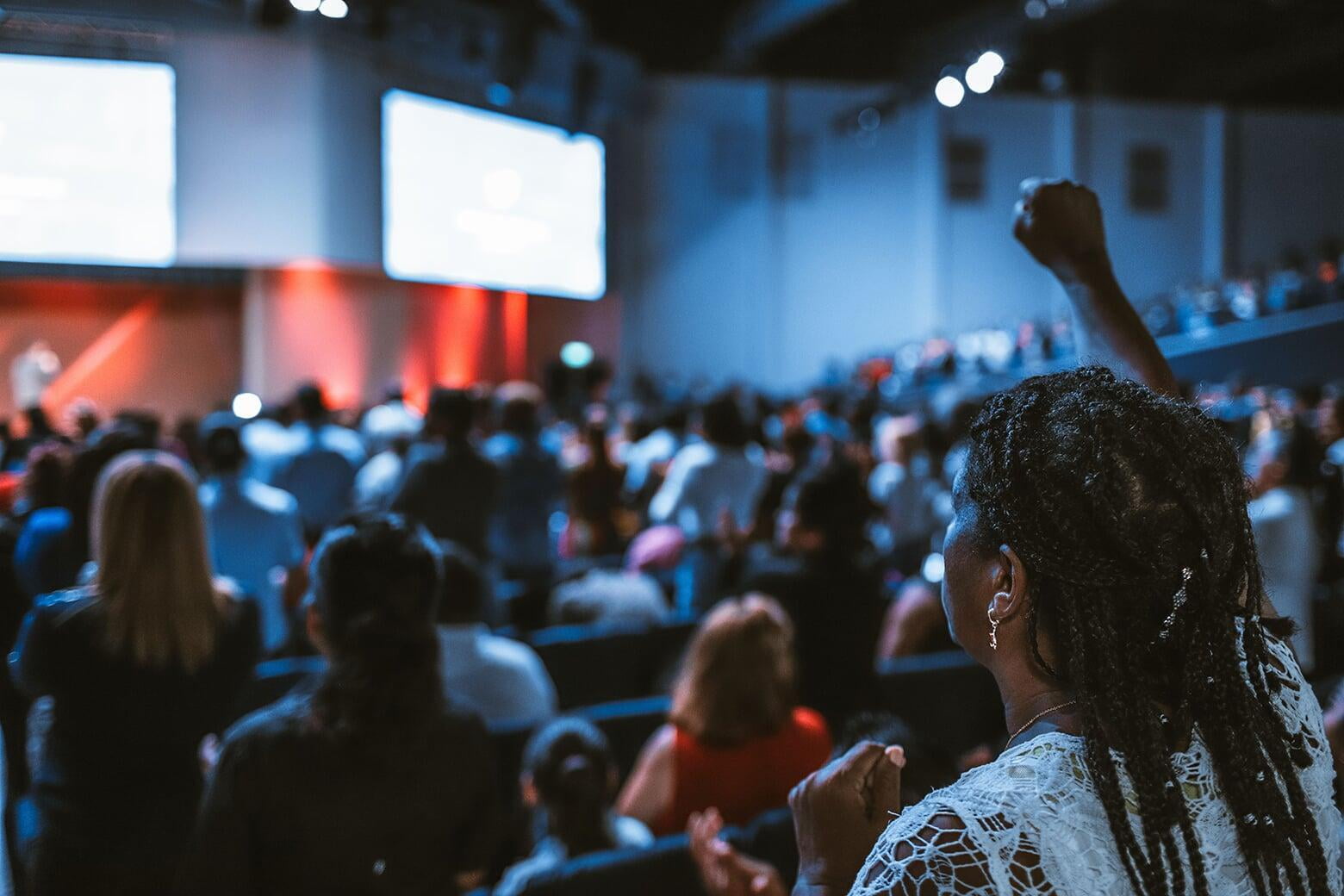 Woman standing strong in large gathering
